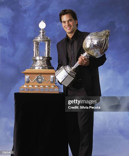 Jose Theodore of the Montreal Canadiens poses for a studio portrait with the Hart Memorial Trophy, awarded to the "Most Valuable Player", and the...