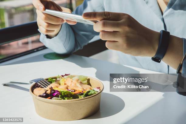 businesswoman taking picture of a salad - salad bowl stock pictures, royalty-free photos & images