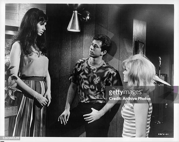 Laurie Mock meets new friends, Gene Kirkwood and Mimsy Farmer in a scene from the film 'Hot Rods To Hell', 1966.