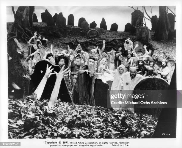 Topal and Norma Crane in a crowd of unknown actors looking as arms are coming out of the earth in a scene from the film 'Fiddler On The Roof', 1971.