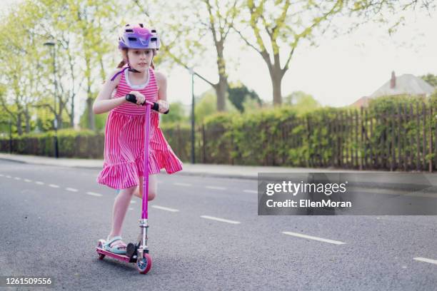 girl on scooter ride - girl riding scooter stock pictures, royalty-free photos & images