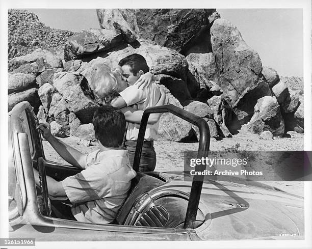 Mimsy Farmer goes for a kiss while Paul Bertoya is in the drivers seat in a scene from the film 'Hot Rods To Hell', 1966.