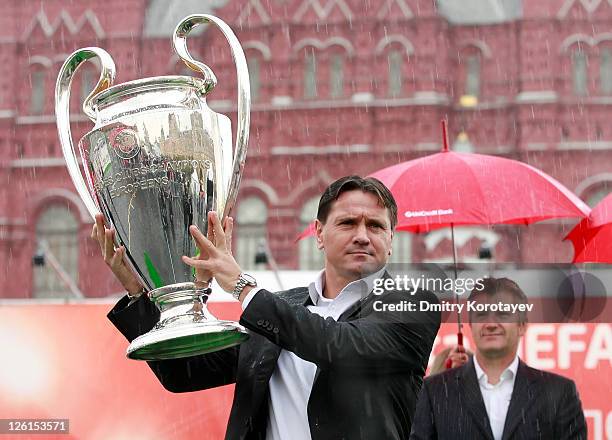 Dmitri Alenichev holds the trophy during the UEFA Champions League Trophy Tour 2011 on September 23, 2011 in Moscow, Russia.