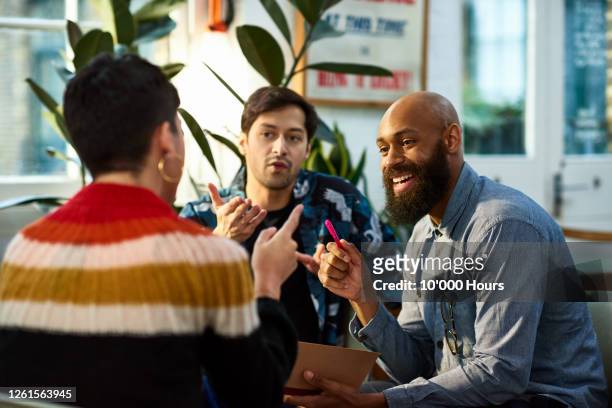 multi ethnic group sharing ideas in office - white collar worker stock pictures, royalty-free photos & images