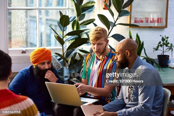 man using laptop with multi racial colleagues - religion bildbanksfoton och bilder
