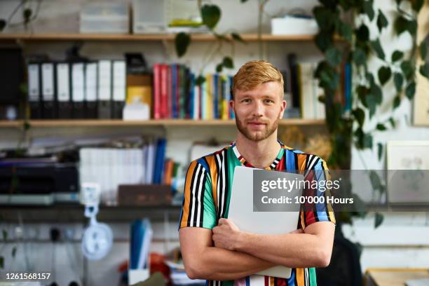 mid adult man standing in office, looking at camera - red head man fotografías e imágenes de stock