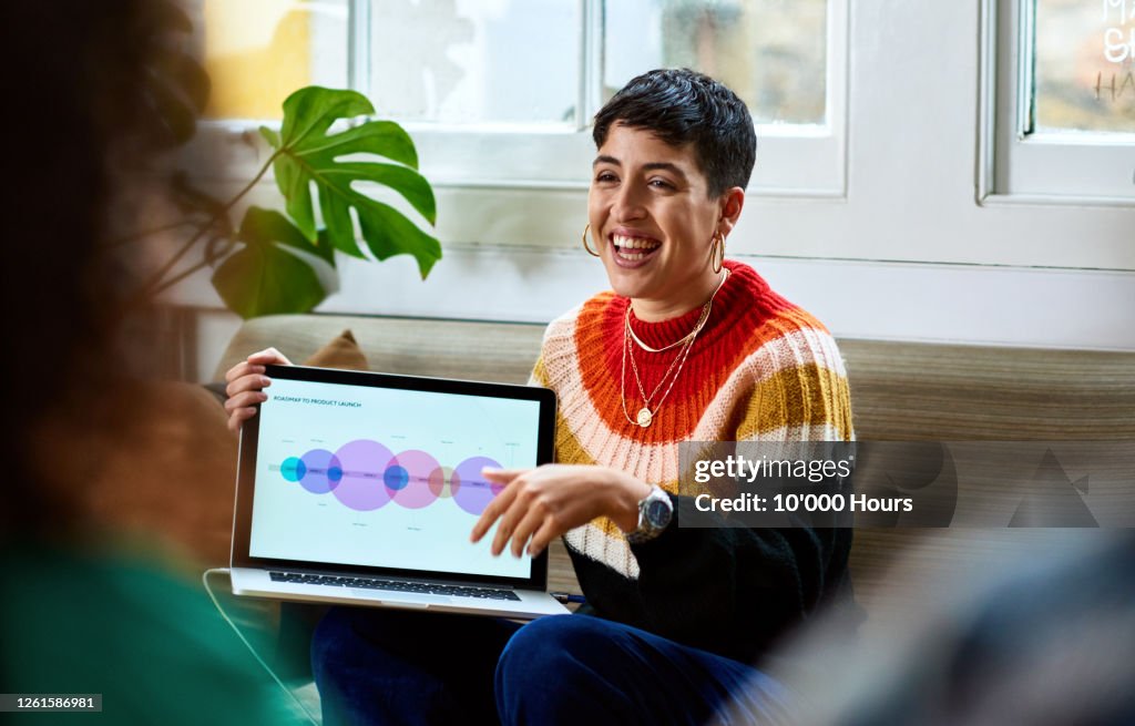 Cheerful young woman with laptop smiling