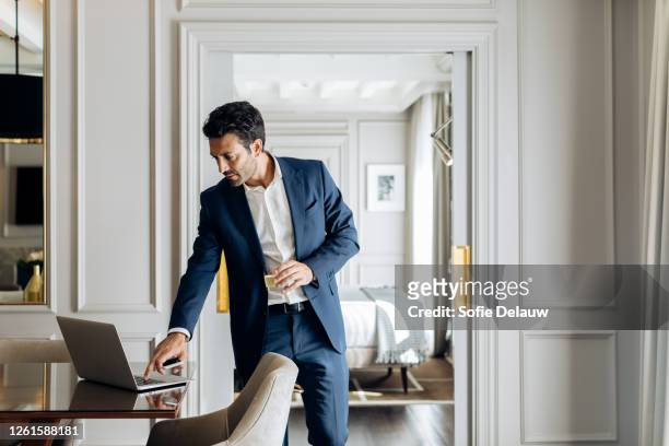 businessman using laptop in suite - businessman hotel ストックフォ��トと画像