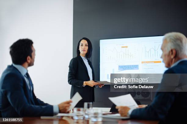 two businessmen meeting at boardroom presentation - presentation to customers stockfoto's en -beelden
