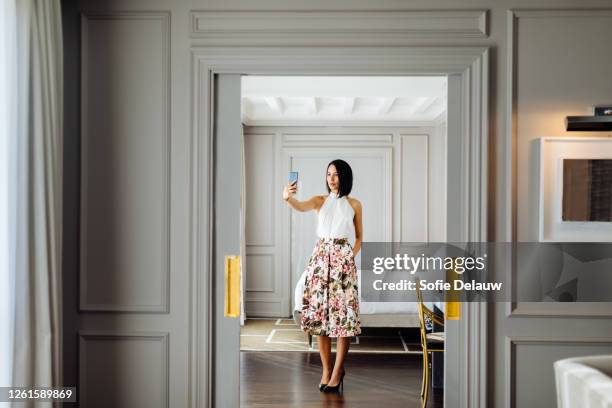 fashionable woman taking selfie in suite - selfie indoors stock pictures, royalty-free photos & images