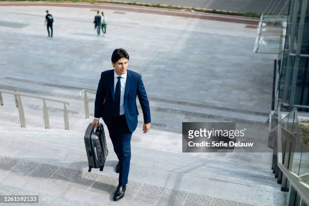 businessman walking up stairway - ties foto e immagini stock