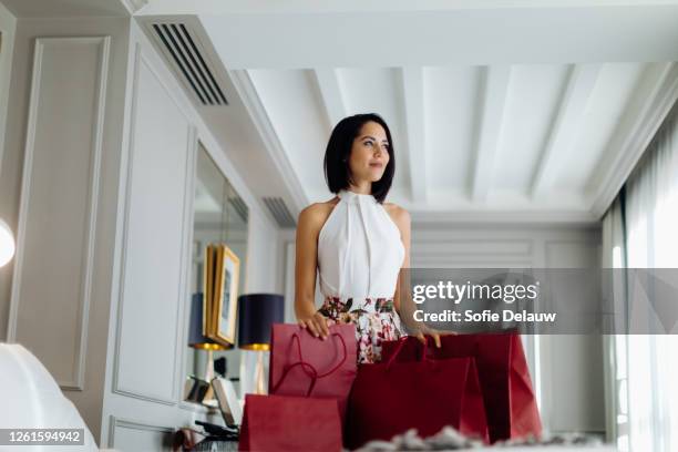 fashionable woman with shopping bags in suite - hotel suite stock pictures, royalty-free photos & images
