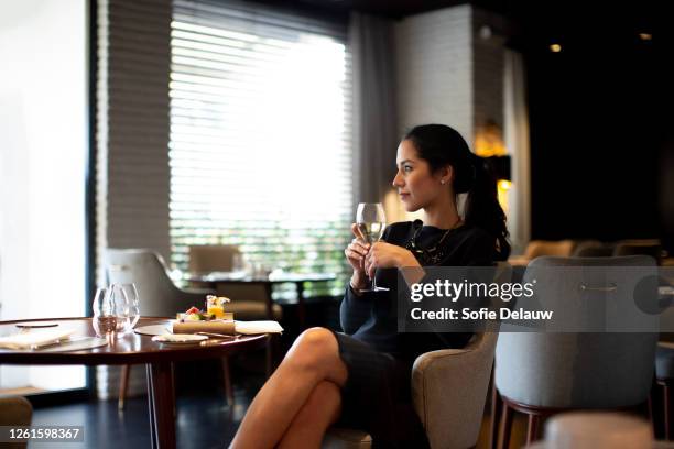 young woman staying in boutique hotel enjoying aperitif - staying in hotel stock pictures, royalty-free photos & images