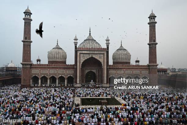 Muslim devotees offer their Eid al-Adha prayers at Jama Masjid in the old quarters of New Delhi on July 29 the feast of the sacrifice marking the end...