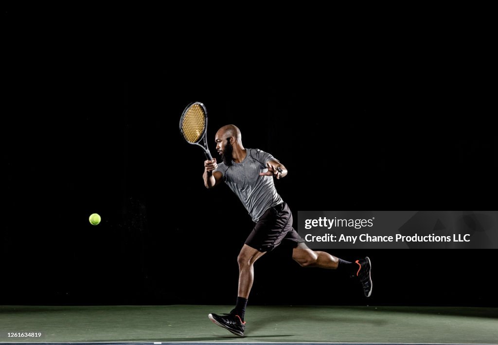 Male tennis player hitting forehand shot