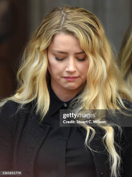 Amber Heard reacts outside the Royal Courts of Justice, the Strand on July 28, 2020 in London, England. The Hollywood actor is suing News Group...