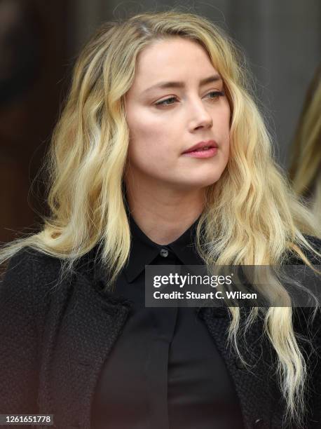 Amber Heard reacts outside the Royal Courts of Justice, the Strand on July 28, 2020 in London, England. The Hollywood actor is suing News Group...