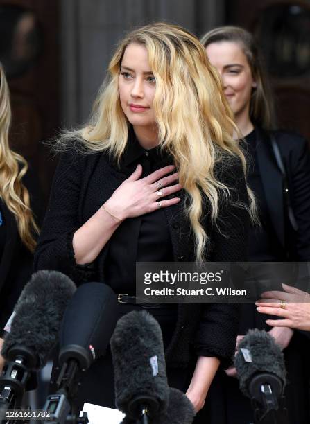Amber Heard reacts outside the Royal Courts of Justice, the Strand on July 28, 2020 in London, England. The Hollywood actor is suing News Group...
