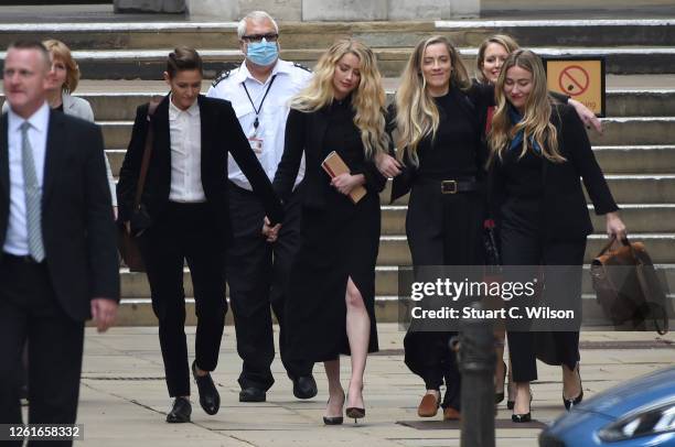 Amber Heard departs with her girlfriend Bianca Butti and sister Whitney Heard, the Royal Courts of Justice, the Strand on July 28, 2020 in London,...