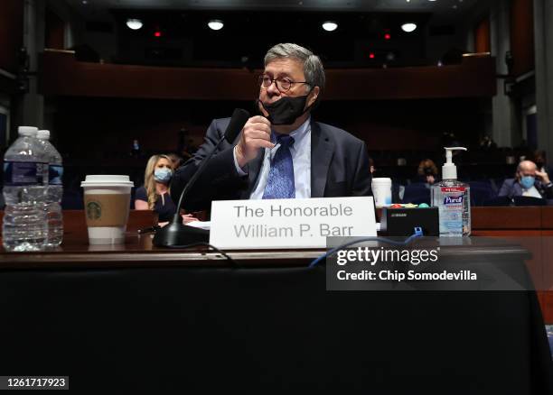 Attorney General William Barr removes his mask after a break in a House Judiciary Committee hearing on Capitol Hill on July 28, 2020 in Washington,...