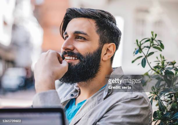 porträt eines glücklichen jungen mannes mit langem bart im freien - turkey middle east stock-fotos und bilder