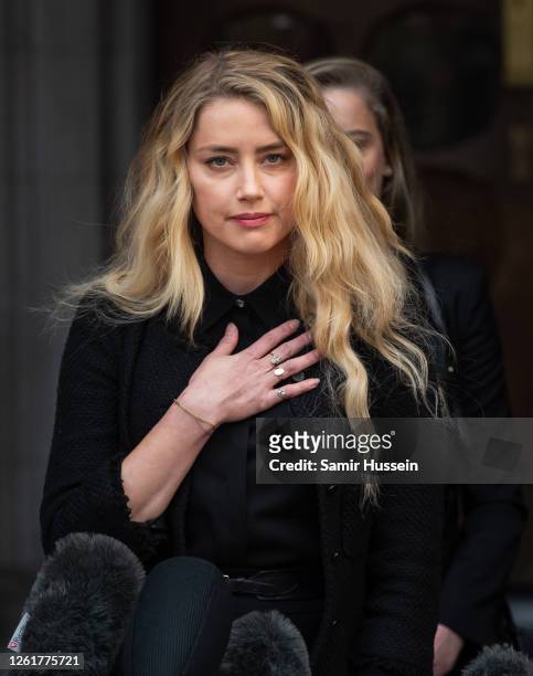 Amber Heard reads a statement after the trial at the Royal Courts of Justice, Strand on July 28, 2020 in London, England. Hollywood Actor Johnny Depp...