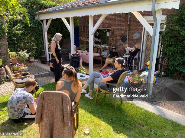 family having a safe distance garden party - family netherlands stock pictures, royalty-free photos & images