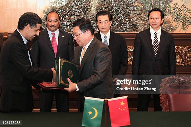 Chinese President Hu Jintao and visiting Mauritanian President Mohamed Ould Abdel Aziz attend a signing ceremony at the Great Hall of the People on...