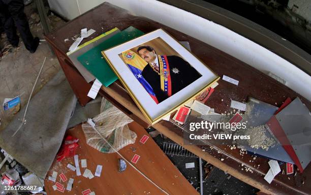 Portrait of Venezuelan President Nicolas Maduro is seen on the floor inside the Venezuelan Consulate after being looted on July 28, 2020 in Bogota,...
