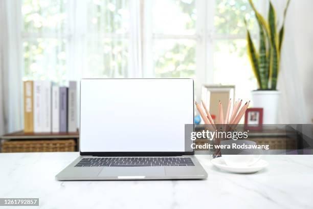 office desk with blank screen laptop placed on marble table - blank book on desk stock pictures, royalty-free photos & images
