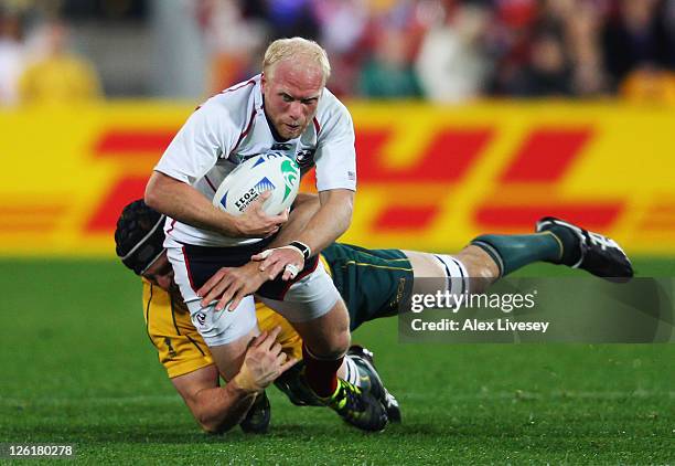 Tim Usasz of the USA is tackled by Dan Vickerman of the Wallabies during match 23 of the IRB 2011 Rugby World Cup between Australia and the USA at...