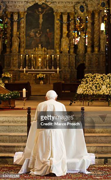 Pope Benedict XVI kneels to pray at the main altar of the Dom cathedral on September 23, 2011 in Erfurt, Germany. The Pope is in Erfurt on the second...