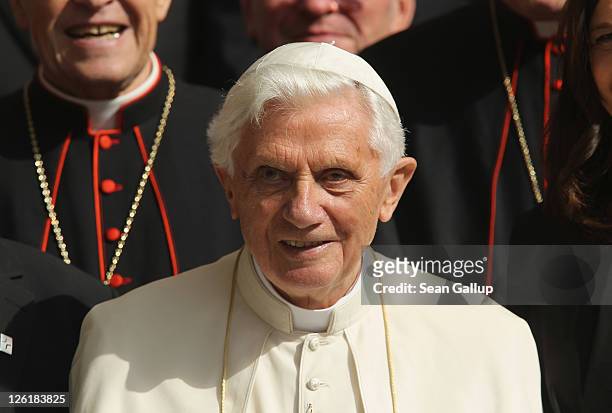 Pope Benedict XVI poses for a group photo with Catholic clergy and other people after leading an ecumenical devotion at Augustinerkloster abbey on...