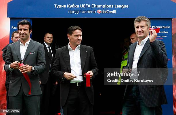 Luis Figo, Dmitri Alenichev and Davor Suker cut tape during opening ceremony of the UEFA Champions League Trophy Tour 2011 on September 23, 2011 in...