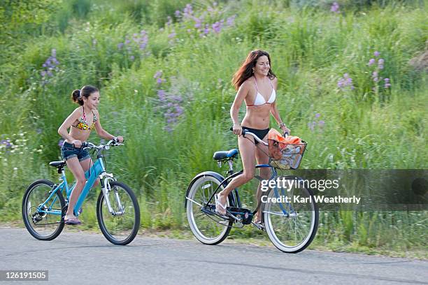 mother and daughter riding bikes - sun valley foto e immagini stock