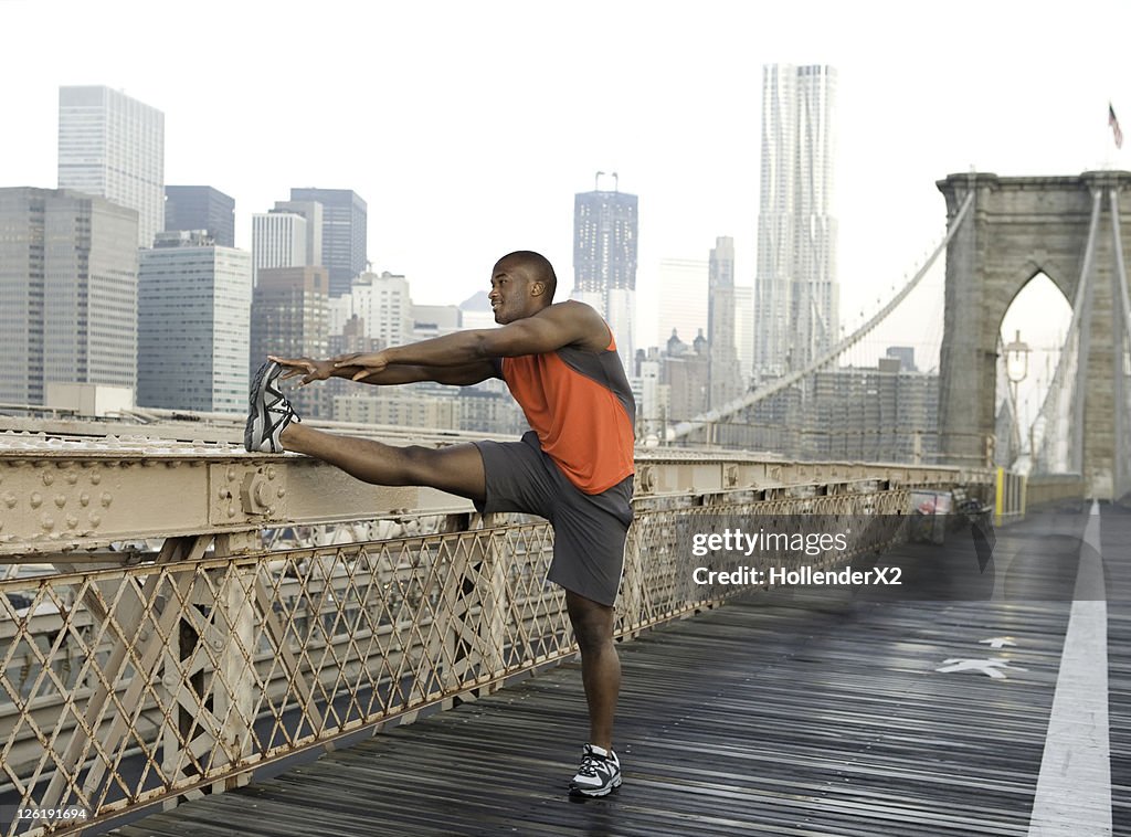 Man stretching on brooklyn bridge