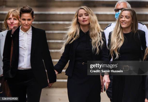 Amber Heard departs with her girlfriend Bianca Butti and sister Whitney Heard from the Royal Courts of Justice, Strand on July 28, 2020 in London,...