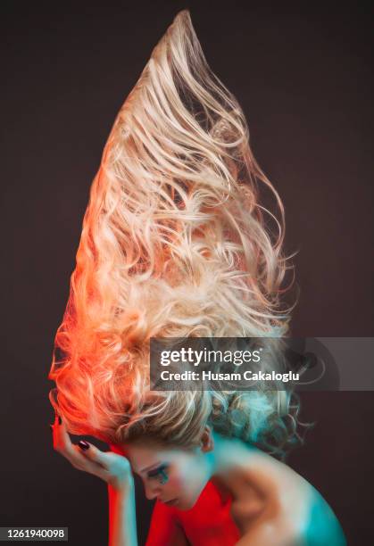 portrait of beautiful woman made of witch makeup and hair front of grey background. - vanguardista imagens e fotografias de stock
