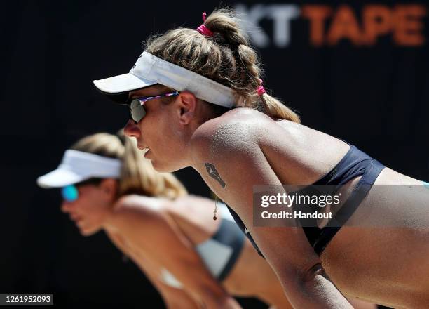 In this handout image provided by AVP, Alix Klineman and April Ross look on against Melissa Humana-Paredes and Sarah Pavan in the final during the...