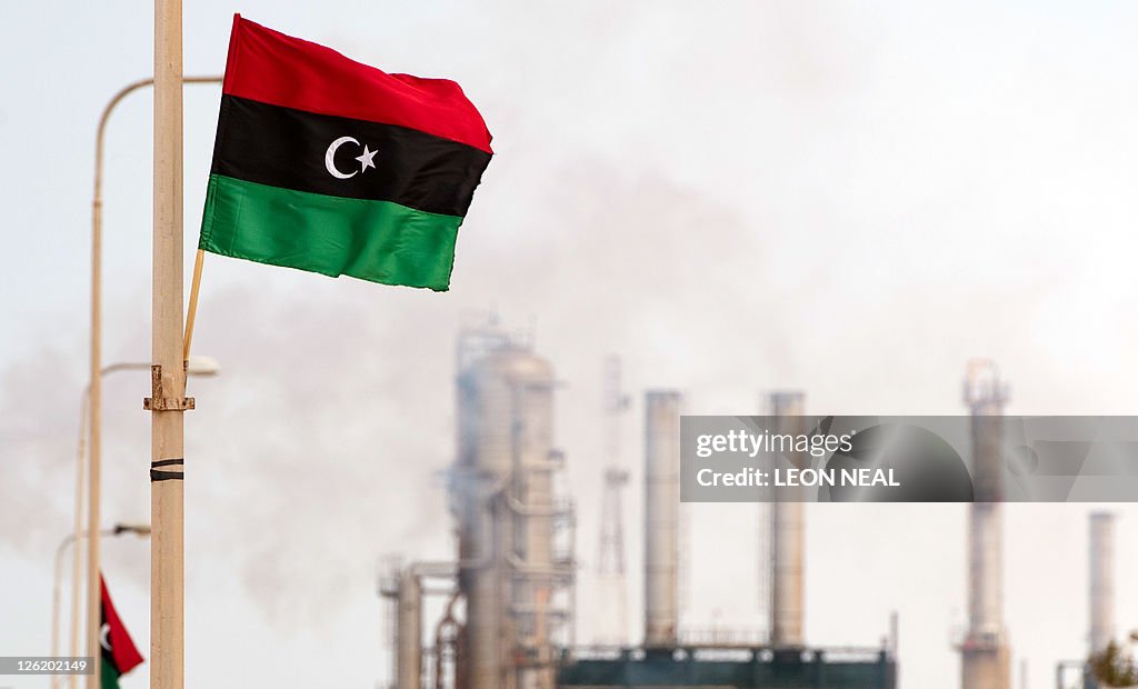 The new Libyan flag flutters outside an