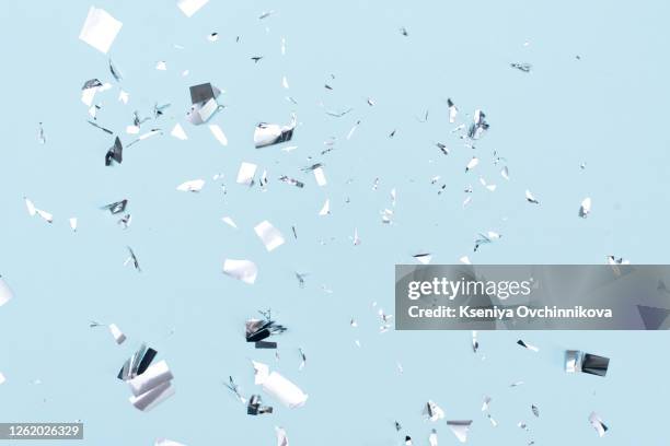 colored confetti flying in the blue sky. are small pieces or streamers of paper, mylar, or metallic material which are thrown at parades and celebrations. - confetti explosion stock-fotos und bilder