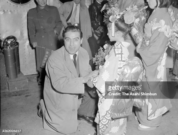 Photographer Robert Capa is seen on arrival at Haneda Airport on April 13, 1954 in Tokyo, Japan.