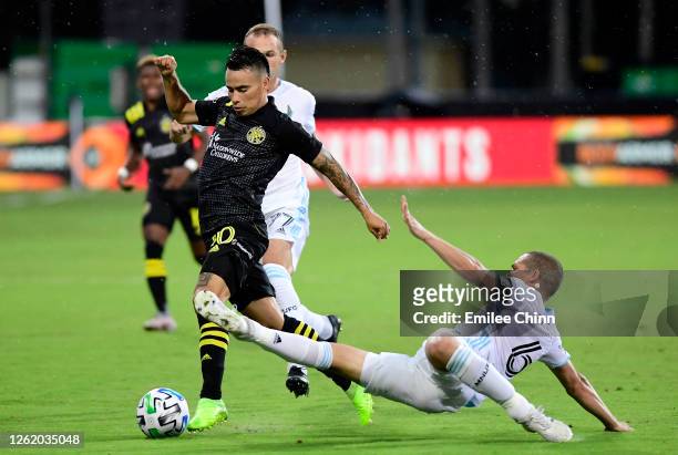 Osvaldo Alonso of Minnesota United slides to protect the ball from Lucas Zelarrayan of Columbus Crew in the first half during a round of sixteen...