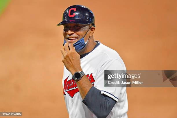 First base coach Sandy Alomar Jr. #15 of the Cleveland Indians jokes with the Chicago White Sox bench during the seventh inning of game 2 of a double...