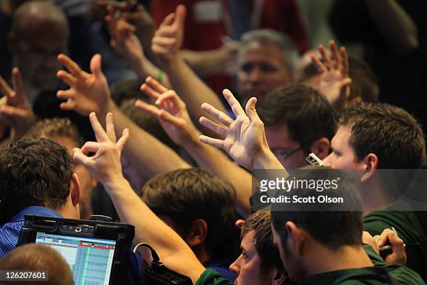 Traders signal offers on Standard & Poor's 500 stock index options at the Chicago Board Options Exchange on September 23, 2011 in Chicago, Illinois....