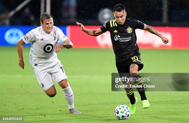 Lucas Zelarrayan of Columbus Crew runs the ball past Robin Lod of Minnesota United during a round of sixteen match in the MLS Is Back Tournament at...