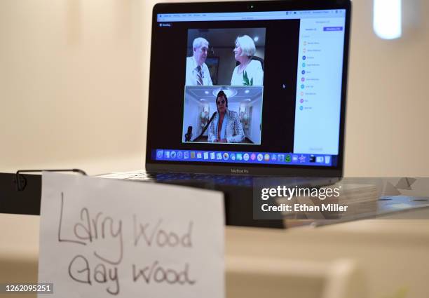 Larry Wood and Gay Wood of Texas are shown on a laptop screen using the Zoom videoconferencing software as Elvis Presley impersonator and chapel...