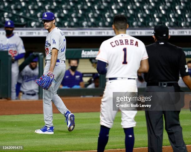 Joe Kelly of the Los Angeles Dodgers has a word with Carlos Correa of the Houston Astros as he walks off the mound after a series of high inside...