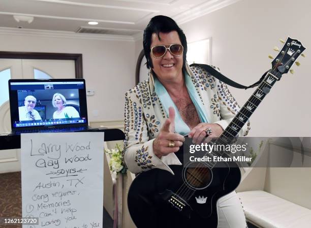 Larry Wood and Gay Wood of Texas are shown on a laptop screen using the Zoom videoconferencing software sharing a kiss as Elvis Presley impersonator...