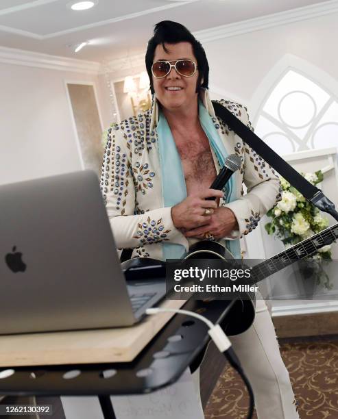 Elvis Presley impersonator and chapel co-owner Brendan Paul performs a live wedding vow renewal ceremony using the Zoom videoconferencing software...